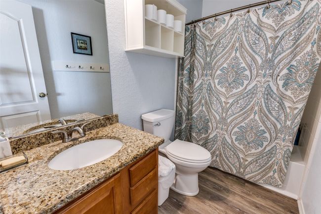 Full bathroom with wood finished floors, toilet, vanity, and shower / bath combo | Image 32
