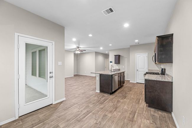 This kitchen area allows for a table that conveniently gives you access to the covered patio. | Image 21