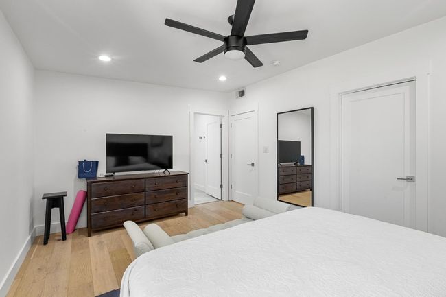 Bedroom with visible vents, baseboards, multiple closets, recessed lighting, and wood finished floors | Image 24
