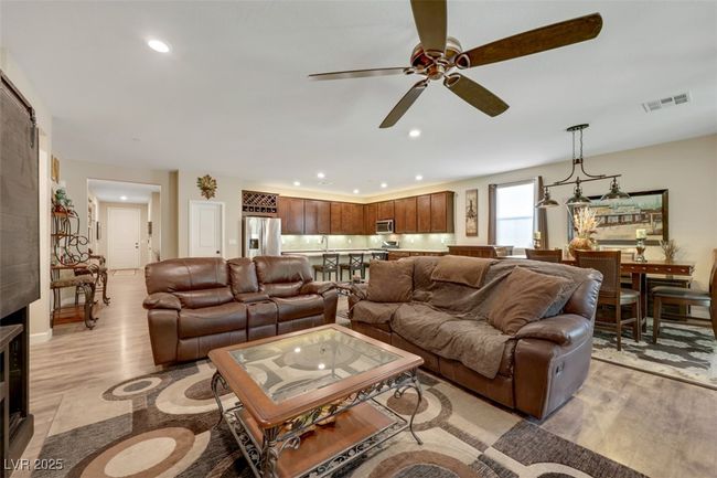 Living room featuring a ceiling fan, light wood-style flooring, recessed lighting, and visible vents | Image 8