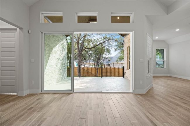 Doorway to outside with lofted ceiling, wood finished floors, and recessed lighting | Image 22