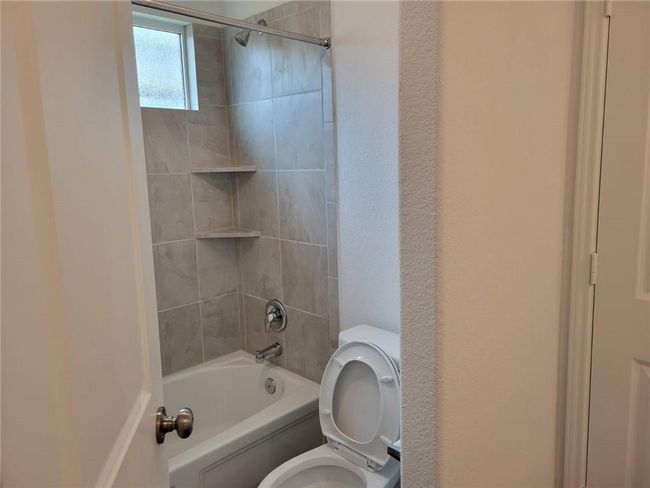 Full bathroom featuring toilet and bathing tub / shower combination | Image 22