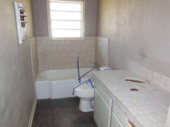 Bathroom with tile patterned floors, a bath, and toilet | Image 5
