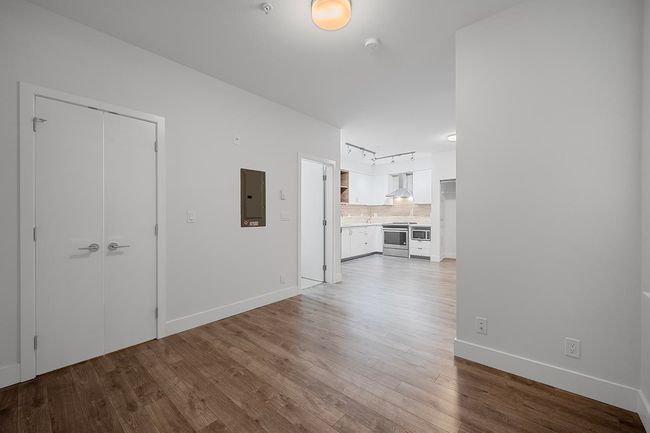 Unfurnished living room featuring electric panel and wood finished floors | Image 18
