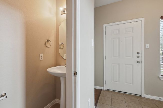 Bathroom with baseboards and tile patterned flooring | Image 15
