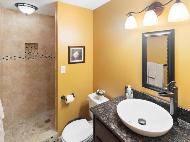 Lower level 3/4 Bath with granite vanity, walk-in tile shower, heated floors | Image 44