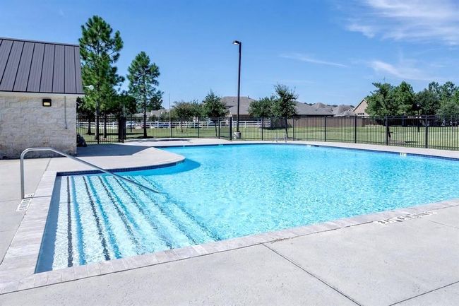 The community outdoor pool with clear blue water. | Image 35