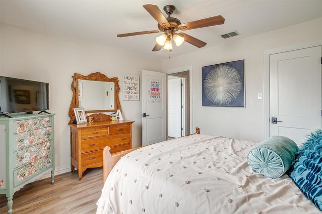 Bedroom with light wood finished floors and a ceiling fan | Image 30