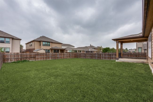 View of yard featuring a fenced backyard and a residential view | Image 26