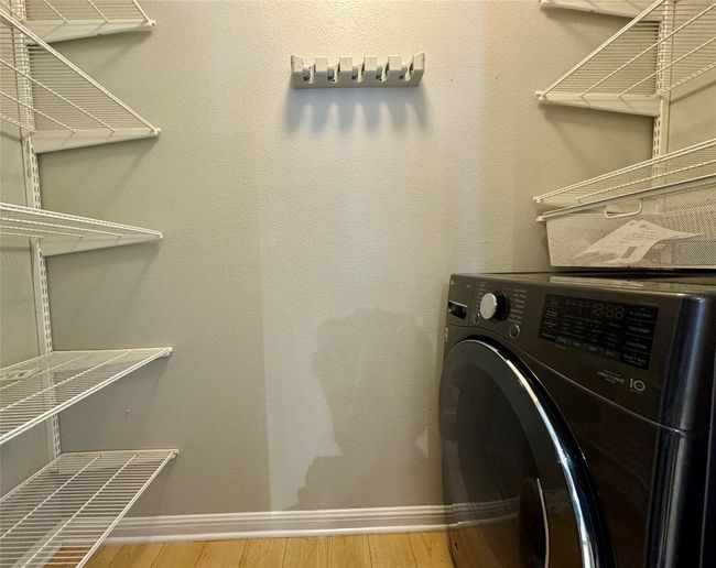 Laundry room with washer / clothes dryer and wood finished floors | Image 9
