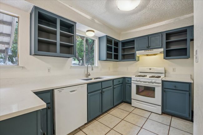 Kitchen featuring open shelves and new quartz countertops | Image 8