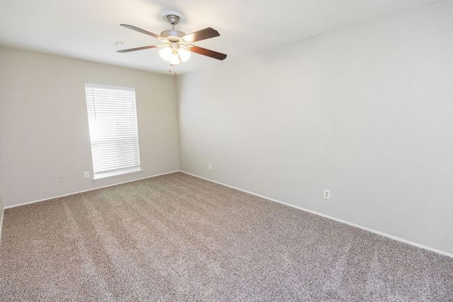 Carpeted empty room featuring ceiling fan | Image 29
