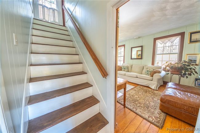 Stairs with a healthy amount of sunlight and wood-type flooring | Image 13