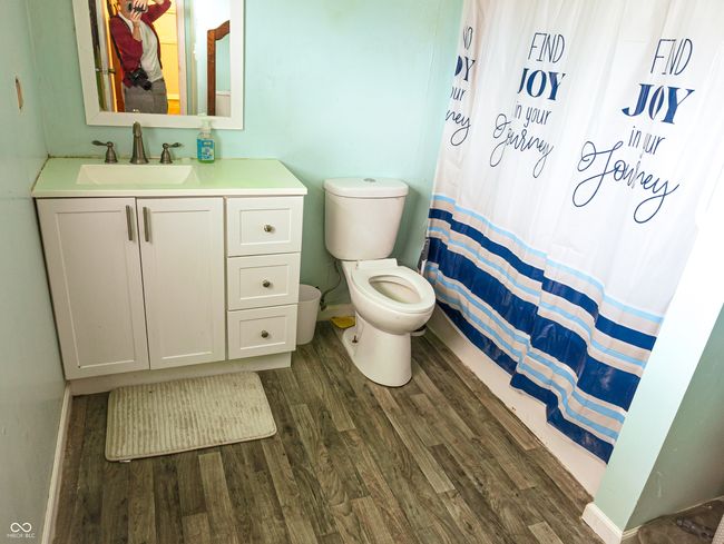 bathroom featuring wood finished floors, toilet, vanity, baseboards, and a shower with curtain | Image 11