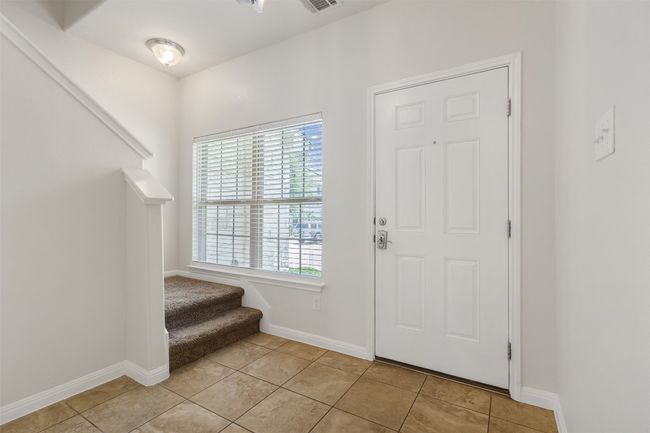 Foyer featuring stairway, plenty of natural light, and light tile patterned floors | Image 5