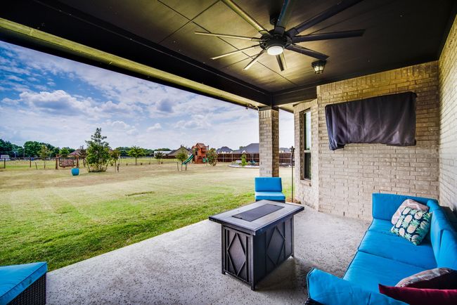 View of patio with ceiling fan and a playground | Image 36