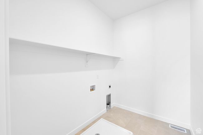 Washroom featuring washer hookup, electric dryer hookup, and baseboards | Image 23