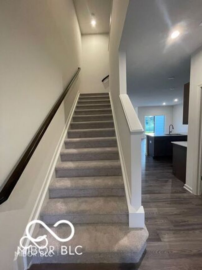 staircase featuring wood finished floors | Image 11