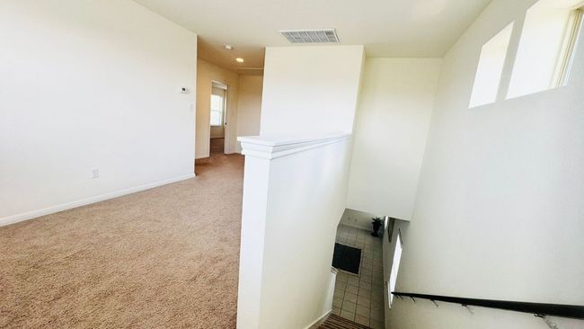 Hallway with carpet floors and baseboards | Image 26