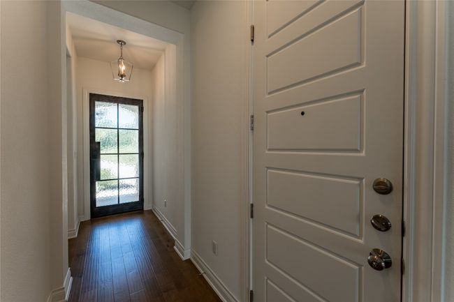 Doorway featuring baseboards and dark wood-style floors | Image 6