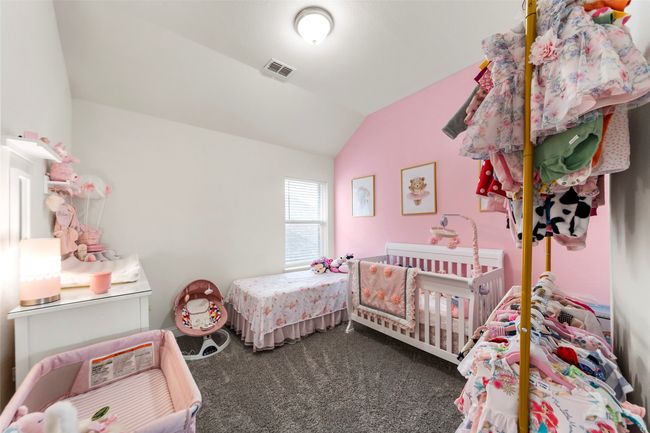 Bedroom featuring dark carpet and lofted ceiling | Image 27