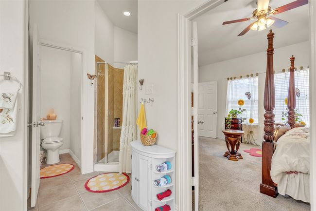 Bathroom with a stall shower, a ceiling fan, and tile patterned flooring | Image 15