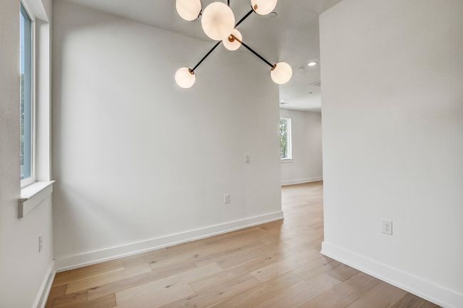 Unfurnished room featuring a chandelier, baseboards, light wood-style flooring, and recessed lighting | Image 14