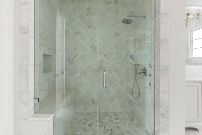 The spa-inspired retreat is complete with a frameless marble shower with over head rain shower, handheld sprayer, body spray jets and bench seating. | Image 23