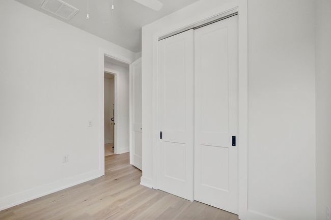 Unfurnished bedroom featuring light wood finished floors, a closet, and baseboards | Image 23