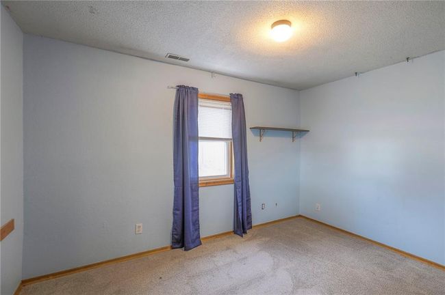 Unfurnished room with baseboards, visible vents, carpet floors, and a textured ceiling | Image 33