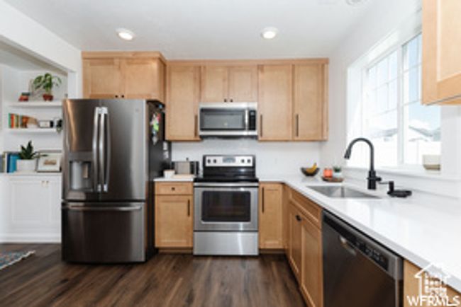 Kitchen featuring stainless steel appliances, a sink, light countertops, and recessed lighting | Image 4