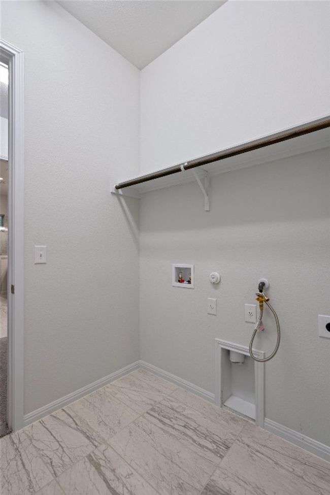 Laundry area with gas dryer hookup, hookup for a washing machine, marble finish floor, laundry area, and hookup for an electric dryer | Image 20