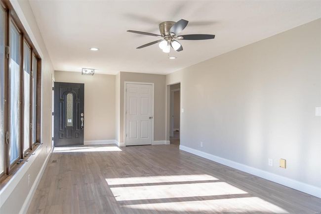 room with ceiling fan, a wealth of natural light, and light/ wood-style flooring | Image 30