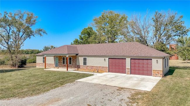 Single story home featuring a front yard and a garage | Image 48
