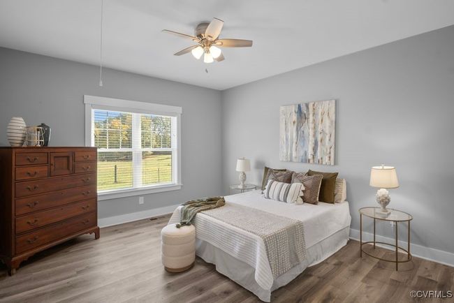 Bedroom with wood finished floors, ceiling fan, and baseboards | Image 20