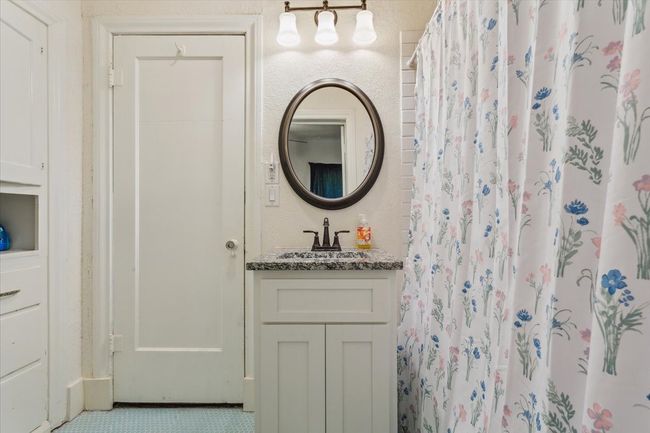 Full bathroom featuring vanity and curtained shower | Image 22