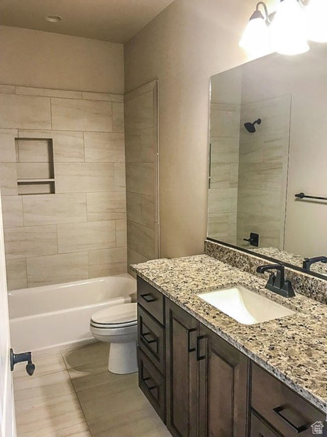 Bathroom featuring shower / bathing tub combination, vanity, and toilet | Image 15