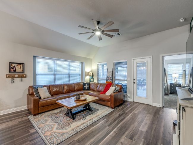 Living room featuring ceiling fan, dark hardwood / wood-style floors, and vaulted ceiling | Image 16