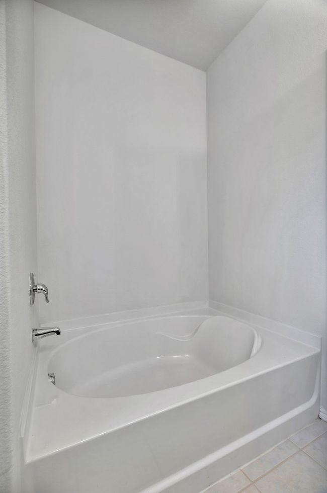 Full bath with a bath and tile patterned floors | Image 21