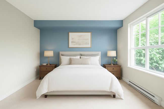 Bedroom featuring baseboards, a baseboard heating unit, multiple windows, and light colored carpet | Image 11