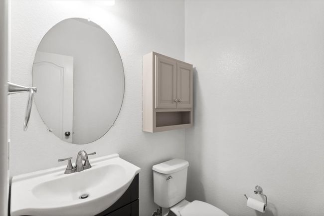 Bathroom featuring a textured wall and vanity | Image 14