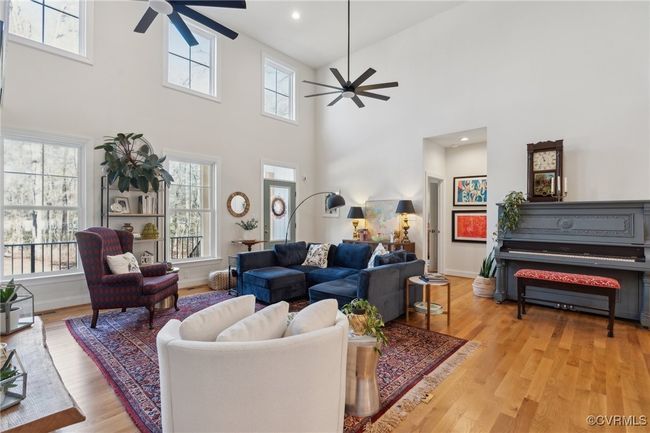 Living room with recessed lighting, light wood-type flooring, baseboards, and ceiling fan | Image 6