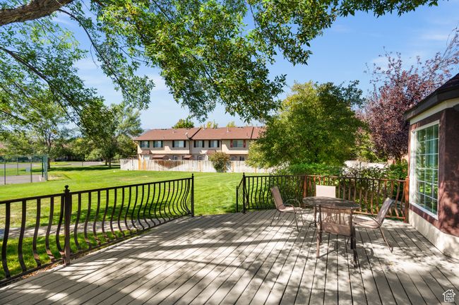 Wooden deck with a yard and outdoor dining space | Image 30