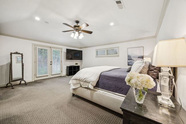 Primary bedroom with french doors leading to the backyard. | Image 11
