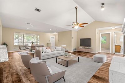 Kitchen with granite island opens to the living/dining areas that feature a WBFP, vaulted ceilings and wall of sliding doors and windows that seamlessly blends the outdoors in, ideal for gatherings with friends & family! | Image 2