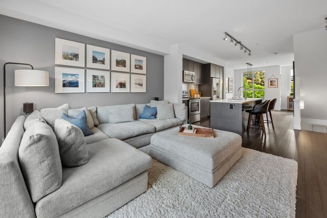 Living room featuring rail lighting and dark wood-type flooring | Image 4