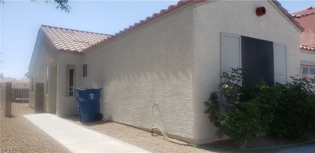 View of property exterior with stucco siding and a tiled roof | Image 14