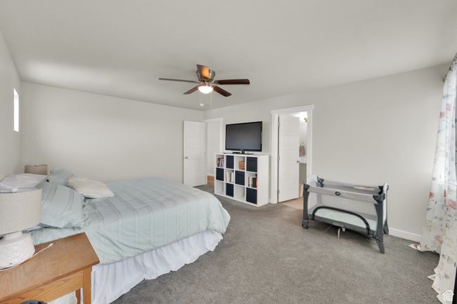 Carpeted bedroom featuring ceiling fan and baseboards | Image 18