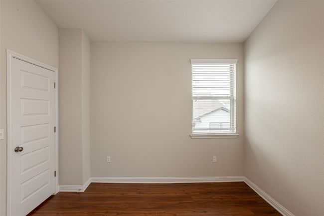 Unfurnished room featuring baseboards, dark wood-style floors, and a healthy amount of sunlight | Image 15