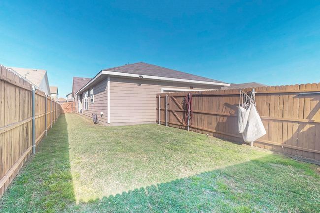 View of yard with a fenced backyard | Image 16